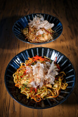 Delicious dishes in bowls served on wooden table