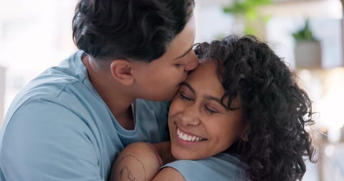 Bedroom, forehead kiss and lesbian couple hug, bond and smile for morning wellness, affection and queer partner relax on bed. Love, home and happy bisexual people embrace in intimate morning together