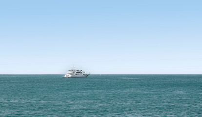Yacht with calm seas and blue skies, with large copy space for text, titles or any other graphic elements