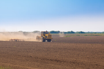 Fototapeta premium Combine plows the field prepares for planting crops.