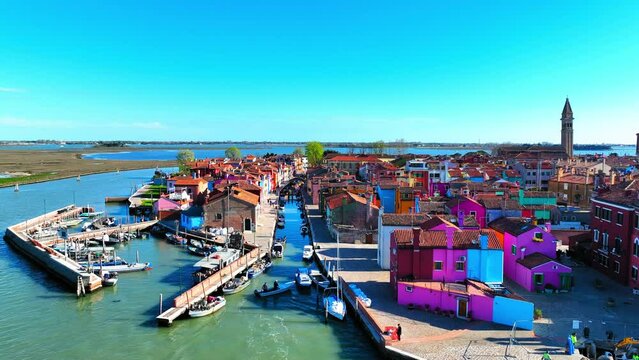 Aerial Forward Shot Of Colorful Houses With People And Boats In City Against Blue Sky On Sunny Day - Venice, Italy