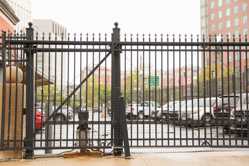 Metal fence: Symbol of boundaries and security; conveys separation and protection. Metaphor for division and safeguarding spaces. Stark, functional