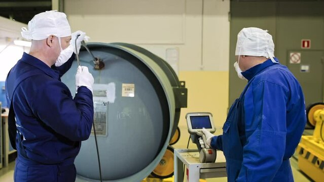 Factory Workers Using Endoscopes Inside A Gas Centrifuge. Controlling The State Of Substance With Endoscopes. Production Process At Electrochemical Plant. Endoscopes To Maintain Enrichment Of Uranium.