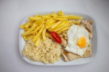 Capture the essence of Alentejo cuisine with 'Bitoque com Ovo a Cavalo' – a traditional dish featuring a juicy pork steak, sunny-side-up egg, and crispy fries.