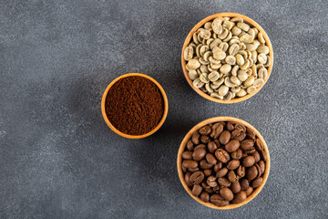 Ground coffee with roasted coffee beans on black background