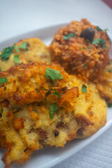 Capture the essence of Alentejo with a classic Portuguese delight: crispy cod fritters served with flavorful tomato rice. A taste of tradition!