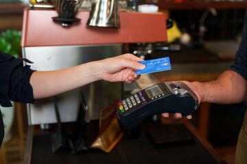 Close-up payment terminal handed out by employee customer make payment, by credit card tapping is credit card payment, for customers who are unable pay with cash, facilitate customers...
