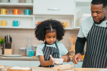 Kind African american parents teaching their adorable daughter how to cook healthy food, free space...