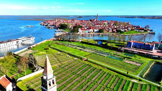 Aerial Shot Of Tower By Vineyard And Sea On Sunny Day, Drone Flying Forward Over Town - Venice, Italy