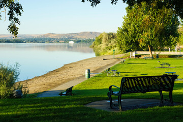 Park benches facing calm Columbia River in Tri-Cities Washington