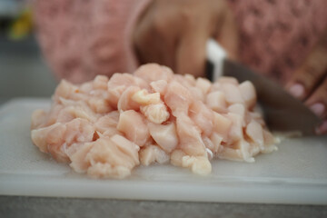 cutting chicken fillet at cooking classes.