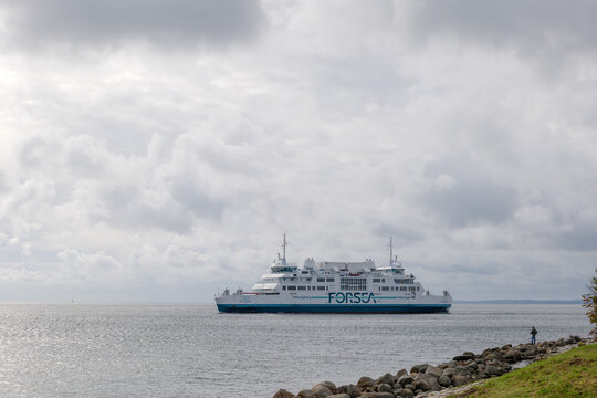 Helsingor, Denmark - OCTOBER 2019: Ferry ship by Forsea Company sail and cloudy sky, view from Kronborg Castle.
