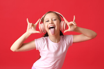 Little girl in headphones showing 