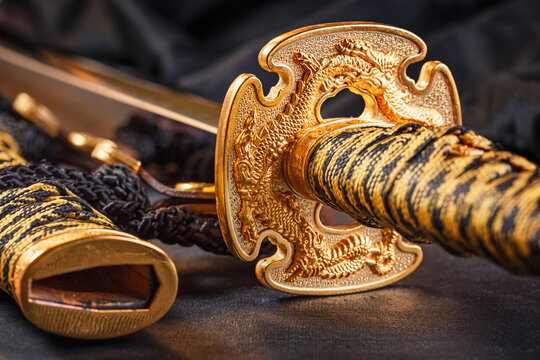 Japanese samurai katana sword and scabbard close up. Photo of a weapon in low key with selective focus