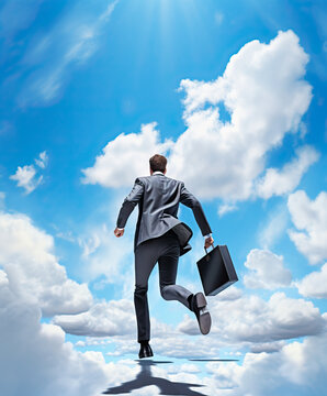 Businessman in a suit, jumping across a blue sky with clouds. Concepts of the sky is the limit, success and good business. 