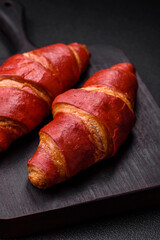 Delicious sweet crunchy red croissant with cream filling