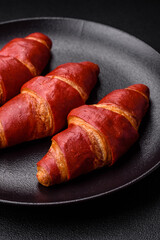 Delicious sweet crunchy red croissant with cream filling