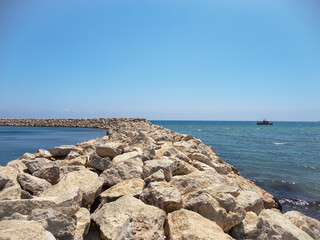 Fototapeta na wymiar The rocky seashore, the waves crashing against the rocks. . High quality photo