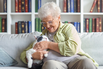 Senior woman with cute cat resting at home