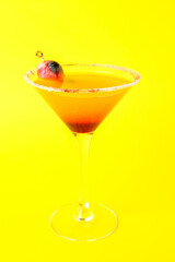 Glass of tasty Margarita cocktail for Halloween on yellow background