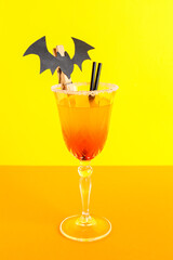 Glass of tasty Margarita cocktail for Halloween on color background