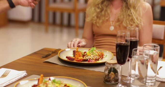 Serving The Food to a blond lady in a fancy restaurant