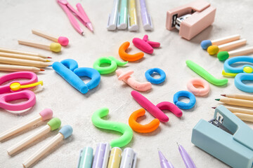 Text BACK TO SCHOOL and stationery on light background
