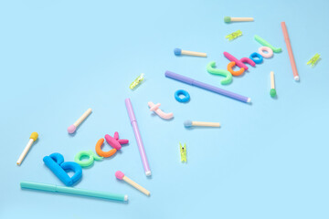 Text BACK TO SCHOOL and stationery on light blue background