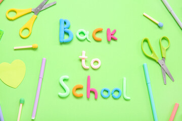 Text BACK TO SCHOOL and stationery on green background
