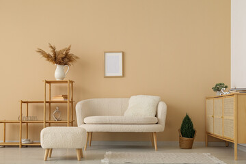 Interior of stylish living room with white sofa, pouf and shelving unit