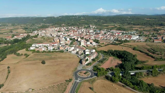Aerial view of a typical catalan village. Mediterranean culture in Europe. Barcelona little town in the middle of agricultural fields.
