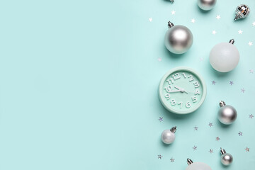 Alarm clock with Christmas decor on blue background