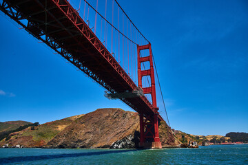 Golden Gate Bridge underside and side view on bright summer day with clear blue skies