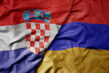 big waving national colorful flag of croatia and national flag of armenia .