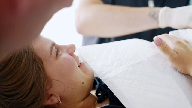Happy first time mom crying holding a newborn on her chest. Happiness of a woman right after labor. Close up.