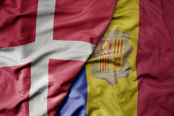 big waving national colorful flag of denmark and national flag of andorra .