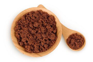 Dark muscovado sugar or Barbados sugar in wooden bowl isolated on white background. Top view. Flat lay