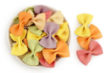 colorful farfalle pasta in ceramic bowl isolated on white background with full depth of field. Top view. Flat lay.