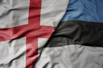 big waving national colorful flag of england and national flag of estonia .