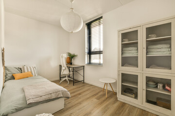 Fototapeta na wymiar a bedroom with white walls and wood flooring the room is clean and ready to be used for bedding