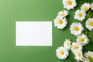 Blank greeting card mockup on green background with white flower