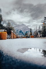 Reflection of the surroundings in a little water puddle in Banff downtown