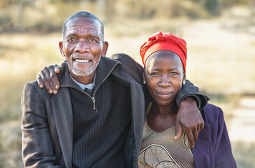 loving old african couple hugging outdoors, endless love, senior citizens lifestyle