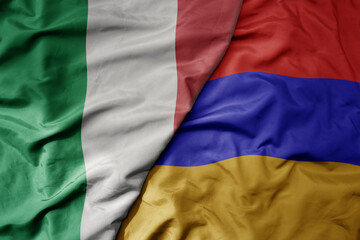 big waving national colorful flag of italy and national flag of armenia .