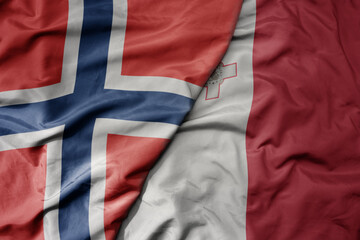 big waving national colorful flag of norway and national flag of malta .