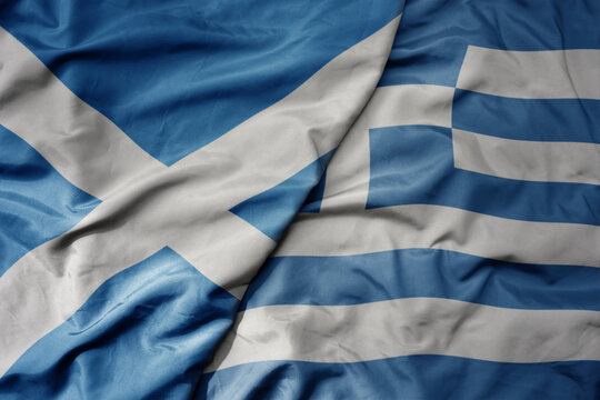 big waving national colorful flag of scotland and national flag of greece .