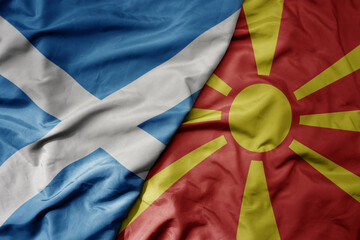 big waving national colorful flag of scotland and national flag of macedonia .