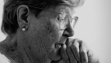 Anxious pensive senior woman in 80s close-up face, authentic candid older person struggling with old age and mental illness