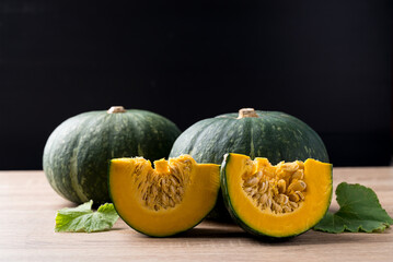 Green pumpkin on wooden with black background, Organic vegetable in autumn season