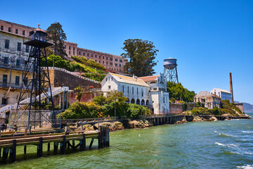 Close up view of Alcatraz Island shoreline lined with buildings and prison